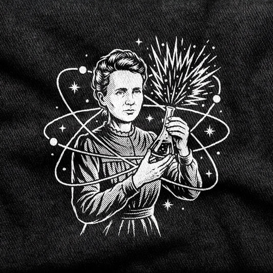 Breaking Atoms Marie Curie design printed on a black cotton tee, close-up