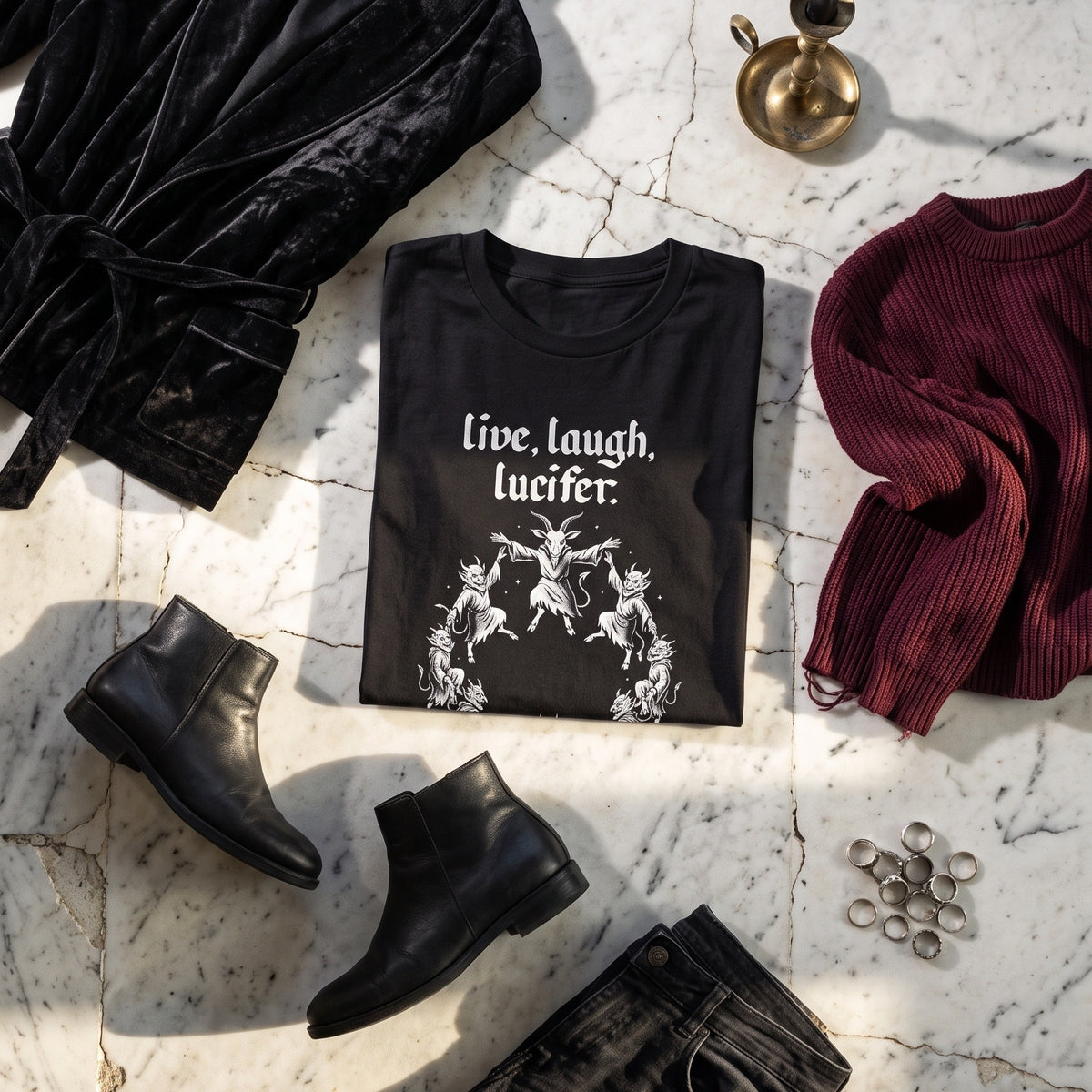 Live Laugh Lucifer black graphic tee styled in a flat lay with matching pieces