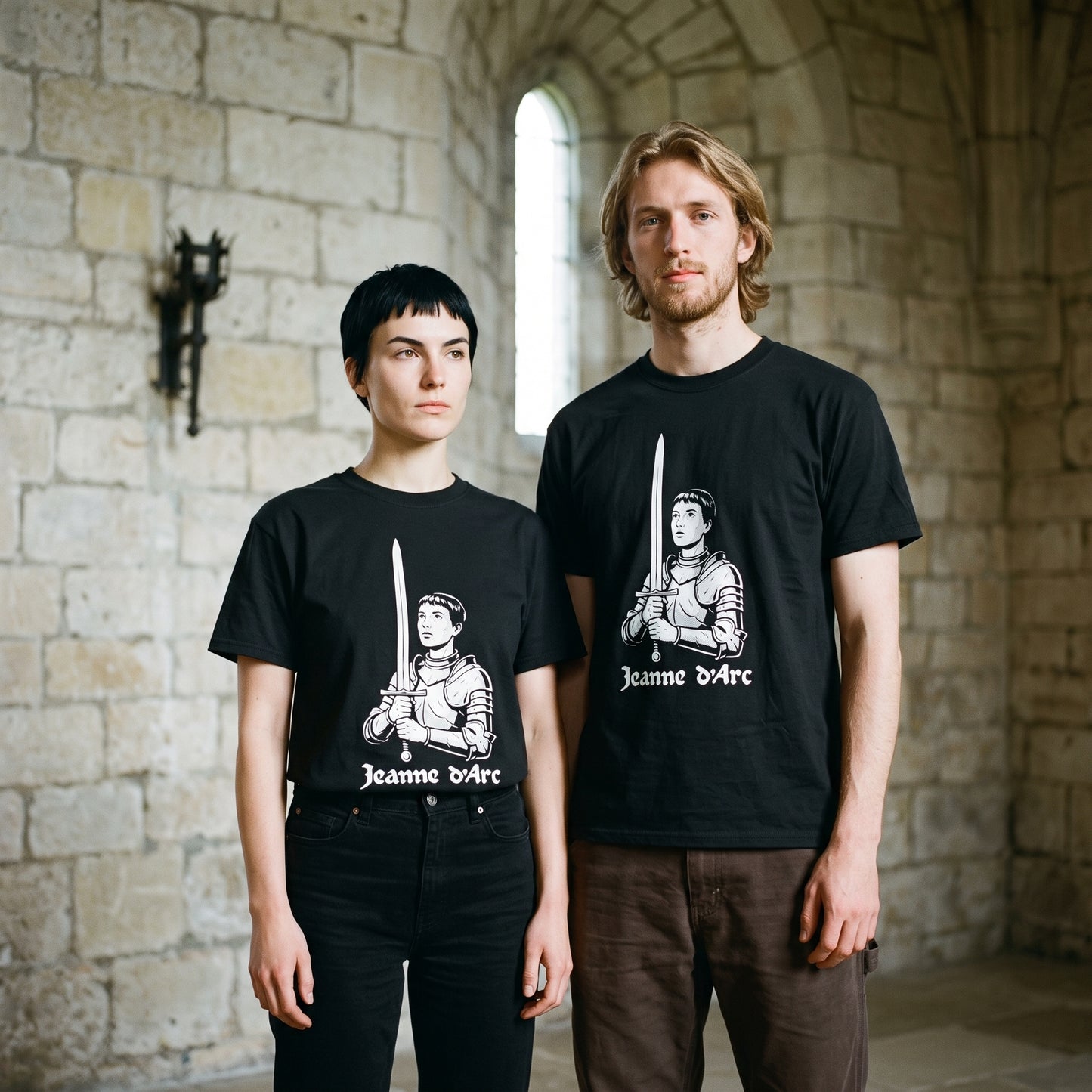 Two models wearing the Jeanne d'Arc black graphic tee