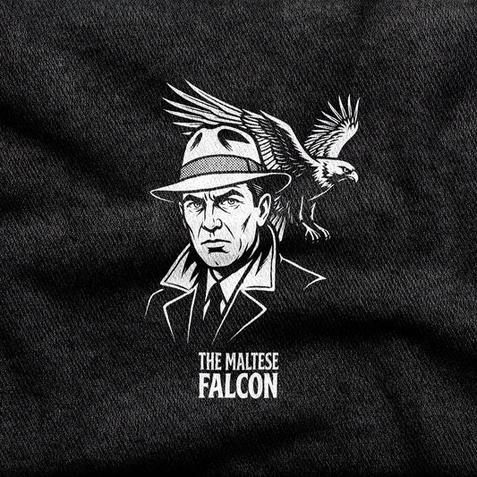 The Maltese Falcon design printed on a black cotton tee, close-up