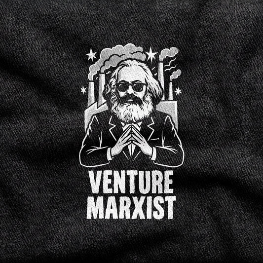 Venture Marxist design printed on a black cotton tee, close-up