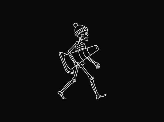 Line drawing of a skeleton in a winter toque walking while carrying a traffic cone