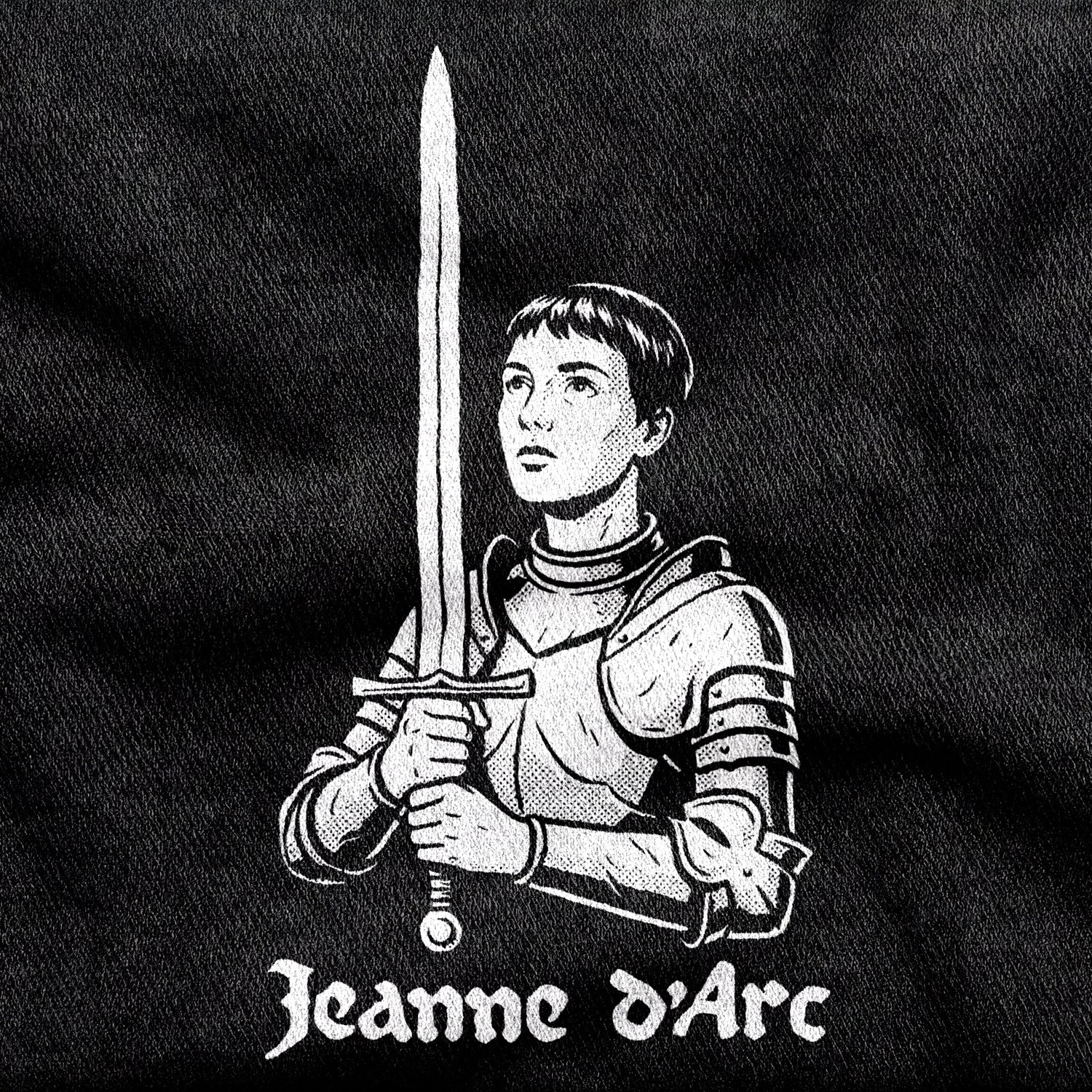 Jeanne d'Arc design printed on a black cotton tee, close-up