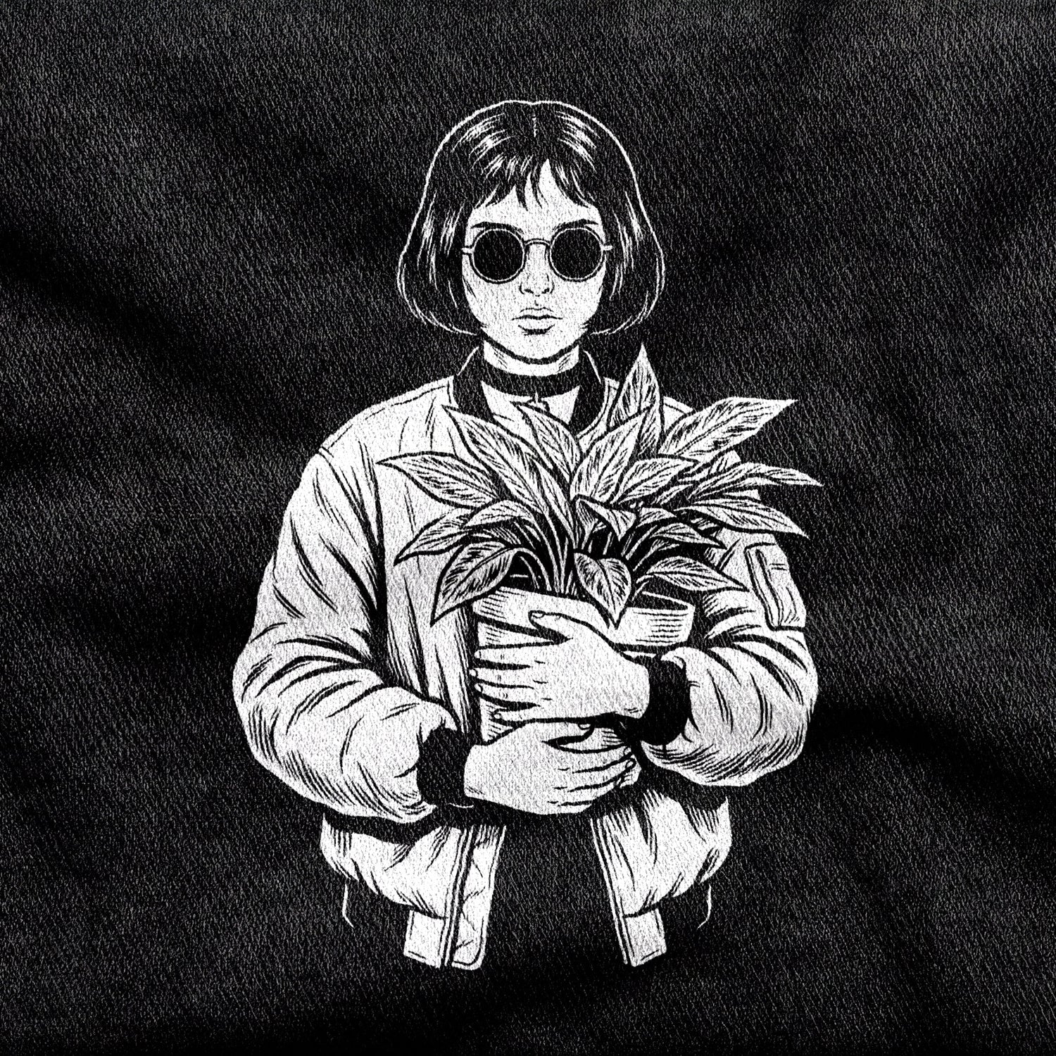 Mathilda design printed on a black cotton tee, close-up