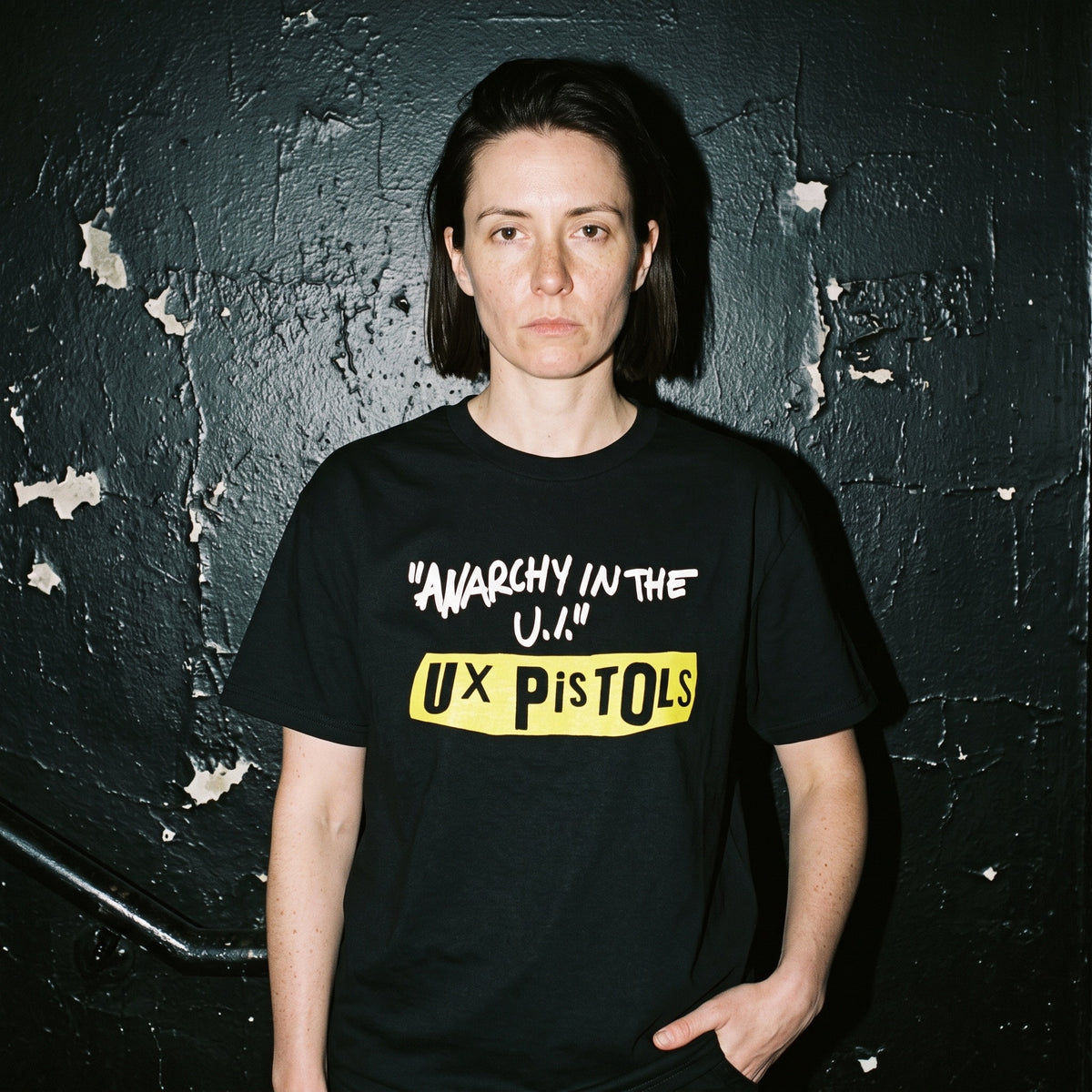 Woman wearing the UX Pistols black graphic tee