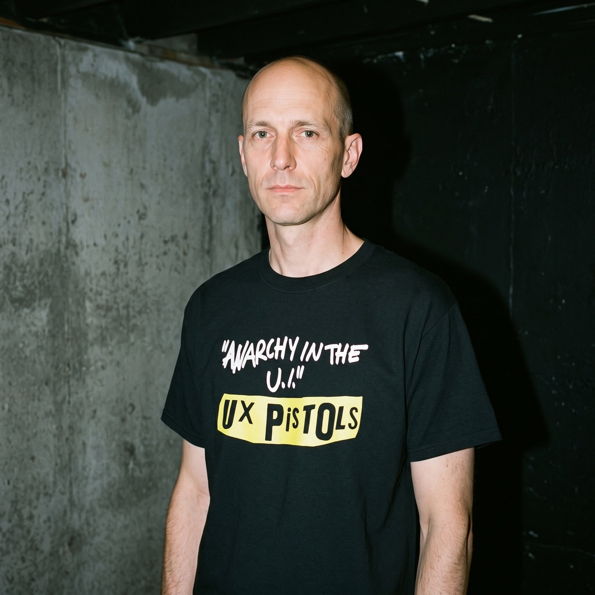 Man wearing the UX Pistols black graphic tee