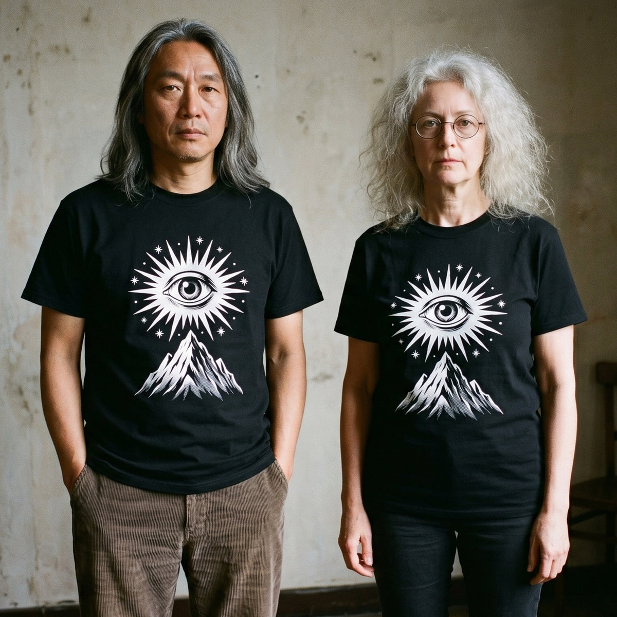 Two models wearing the Amon Düül II black graphic tee