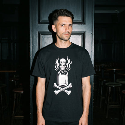 Man wearing the Drink Your Poison black graphic tee