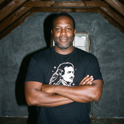 Man wearing the Nevermore Edgar Allan Poe black graphic tee