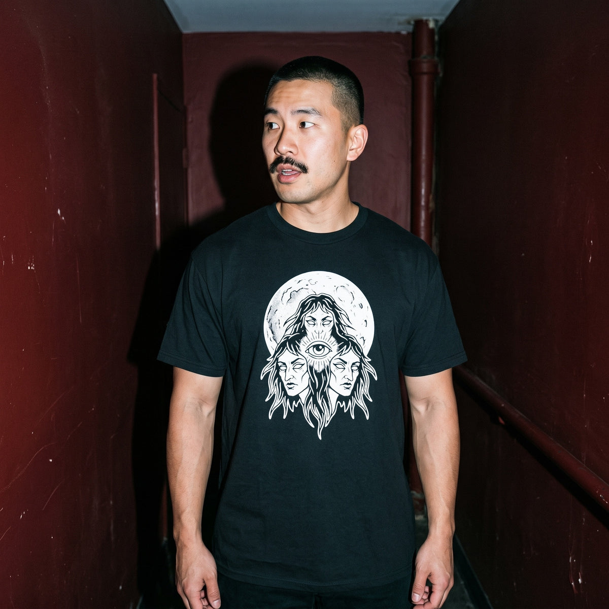 Man wearing the Three Mothers black graphic tee