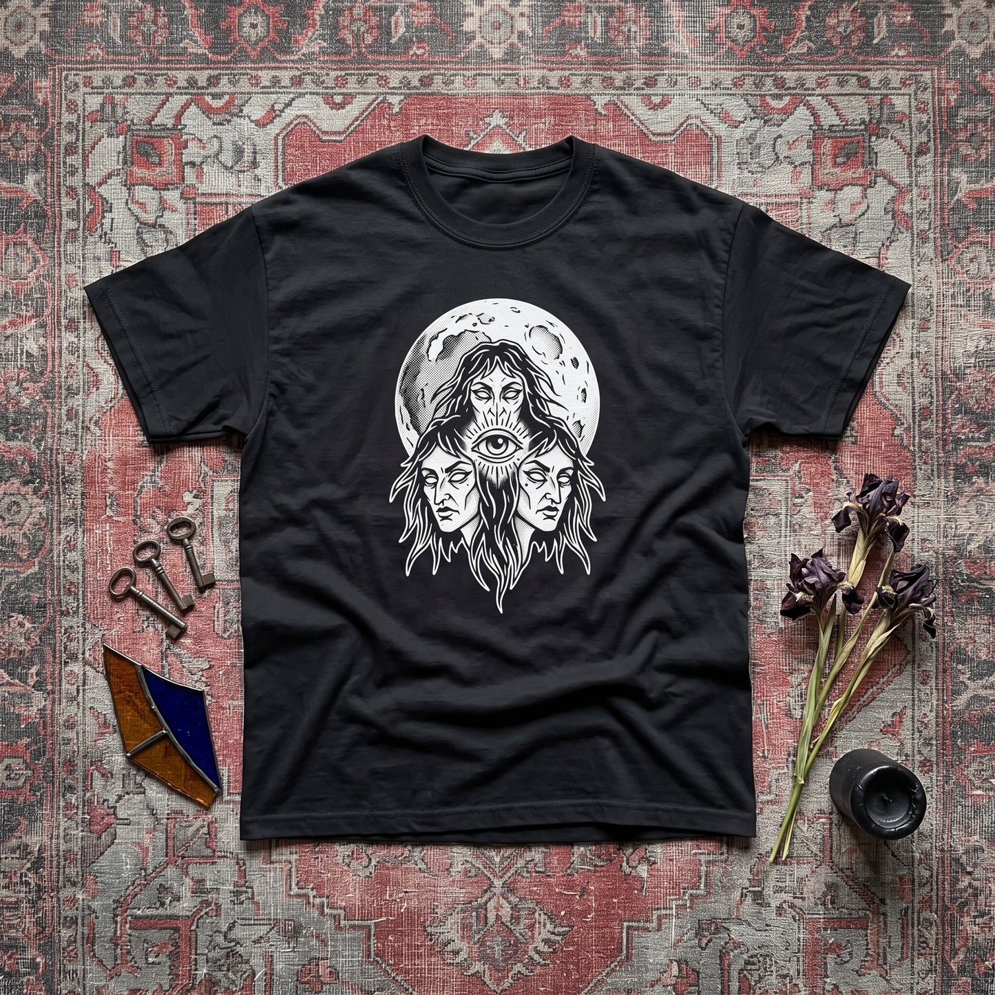 Three Mothers black graphic tee, styled flat lay