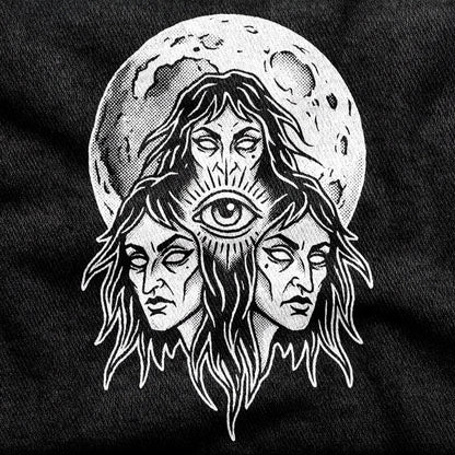 Three Mothers design printed on a black cotton tee, close-up