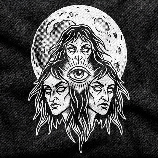 Three Mothers design printed on a black cotton tee, close-up