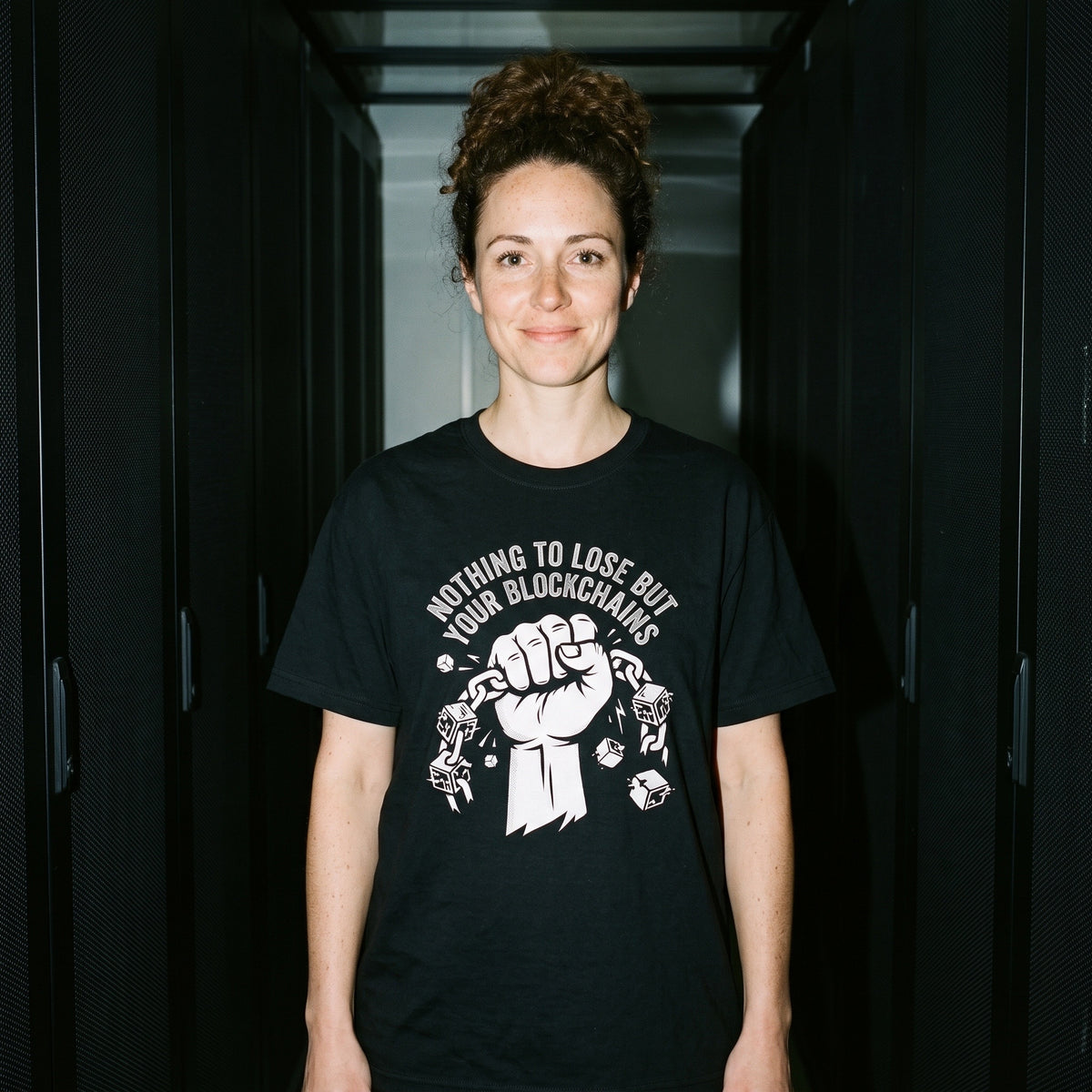 Woman wearing the Nothing to Lose But Your Blockchains black graphic tee