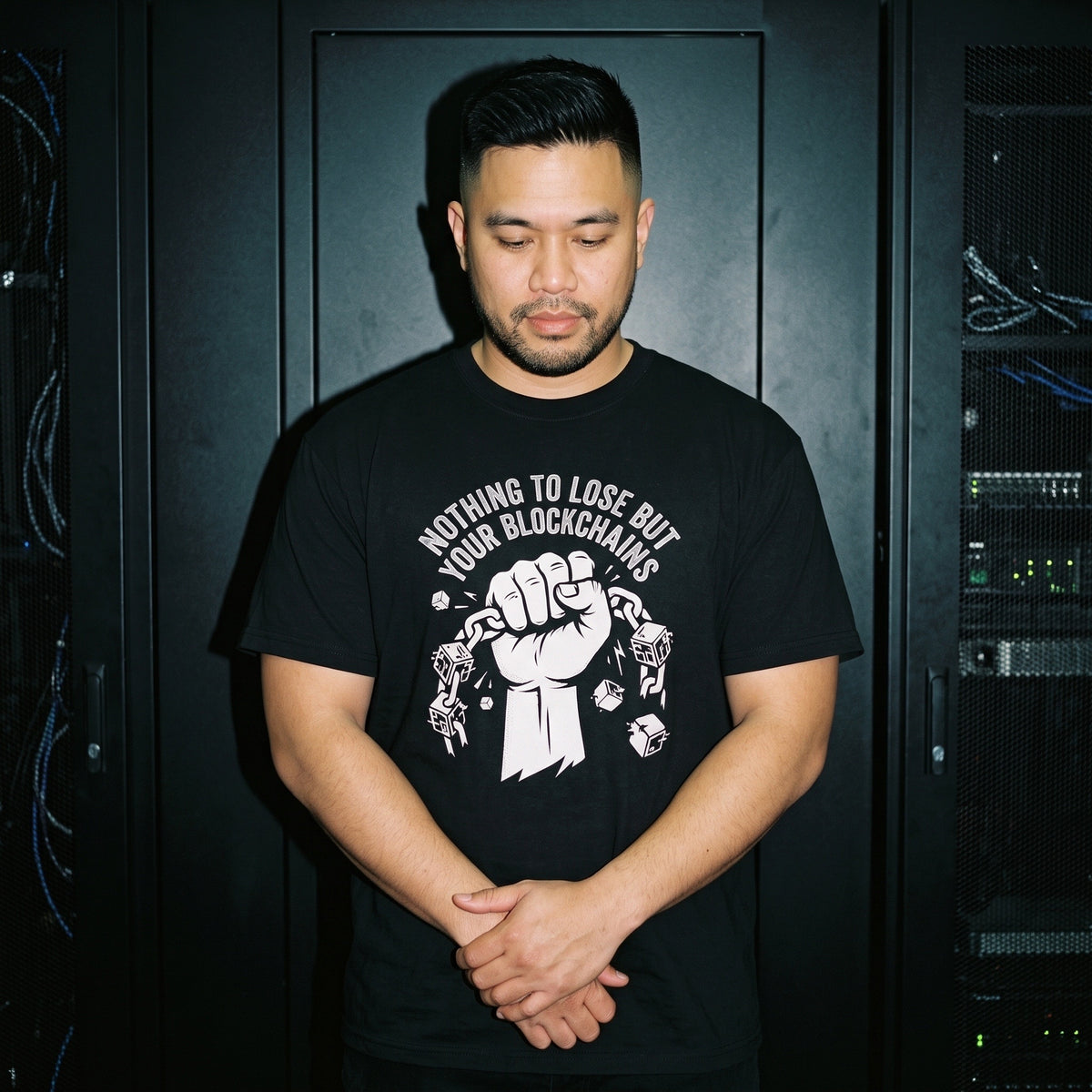 Man wearing the Nothing to Lose But Your Blockchains black graphic tee