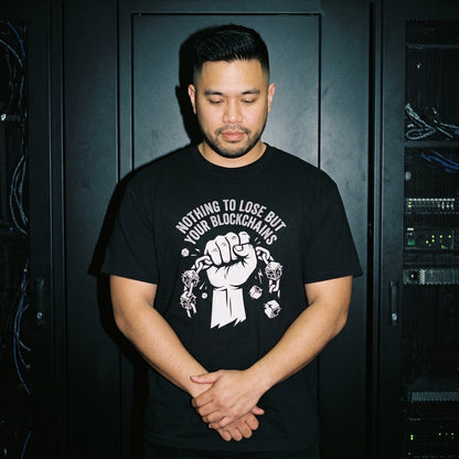Man wearing the Nothing to Lose But Your Blockchains black graphic tee