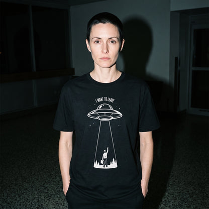 Woman wearing the I Want to Leave black graphic tee