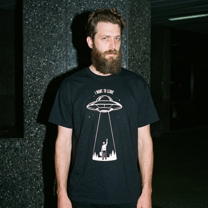 Man wearing the I Want to Leave black graphic tee
