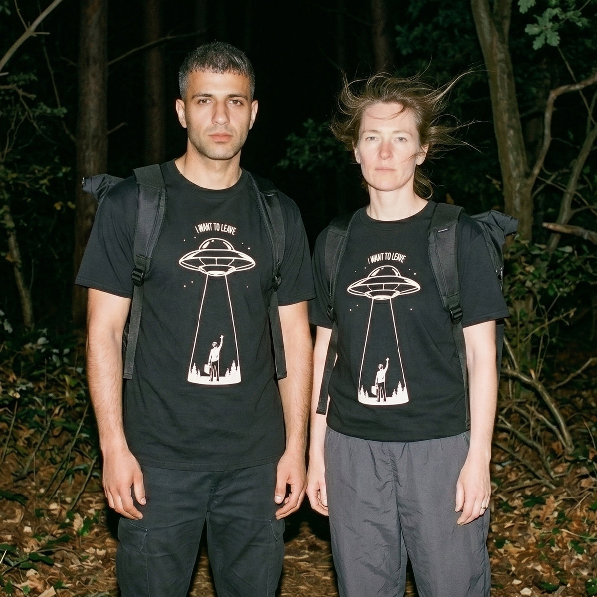 Two models wearing the I Want to Leave black graphic tee