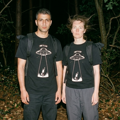 Two models wearing the I Want to Leave black graphic tee