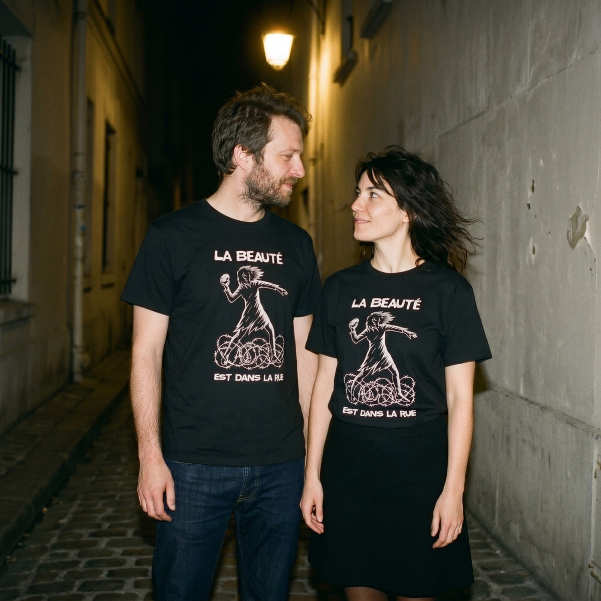 Two models wearing the La Beauté est dans la Rue black graphic tee