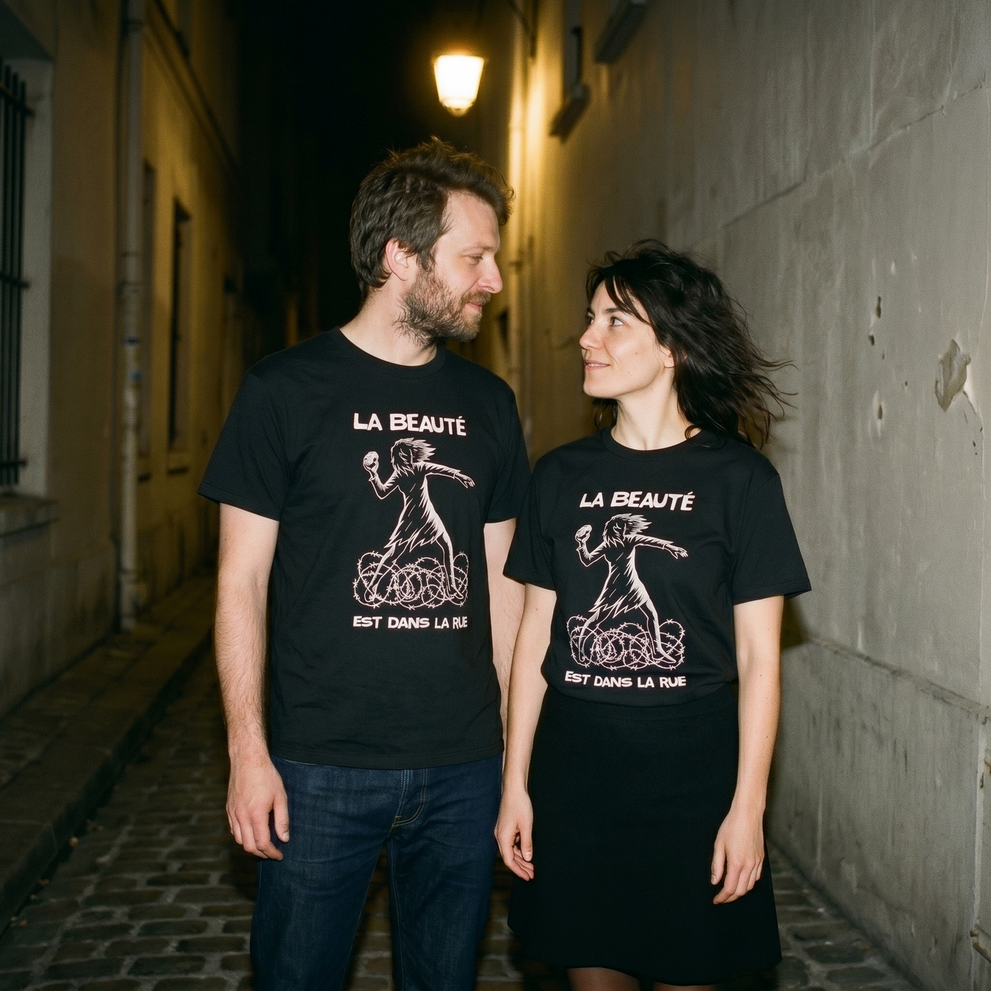 Two models wearing the La Beauté est dans la Rue black graphic tee