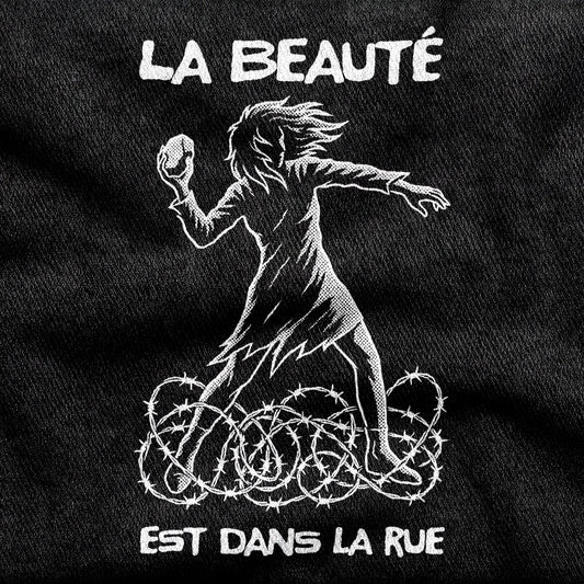La Beauté est dans la Rue design printed on a black cotton tee, close-up