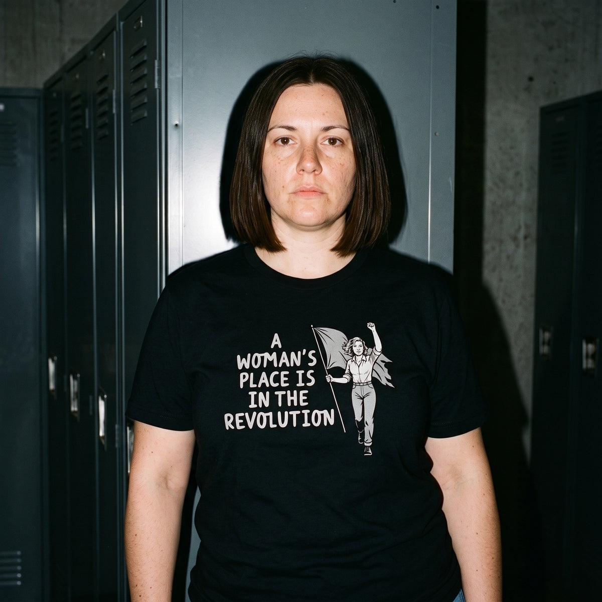 Woman wearing the A Woman's Place is in the Revolution black graphic tee
