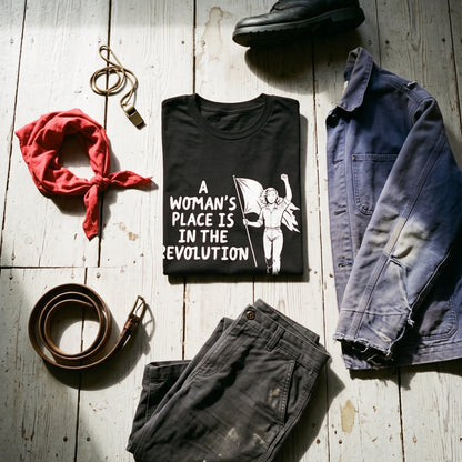 A Woman's Place is in the Revolution black graphic tee styled in a flat lay with matching pieces