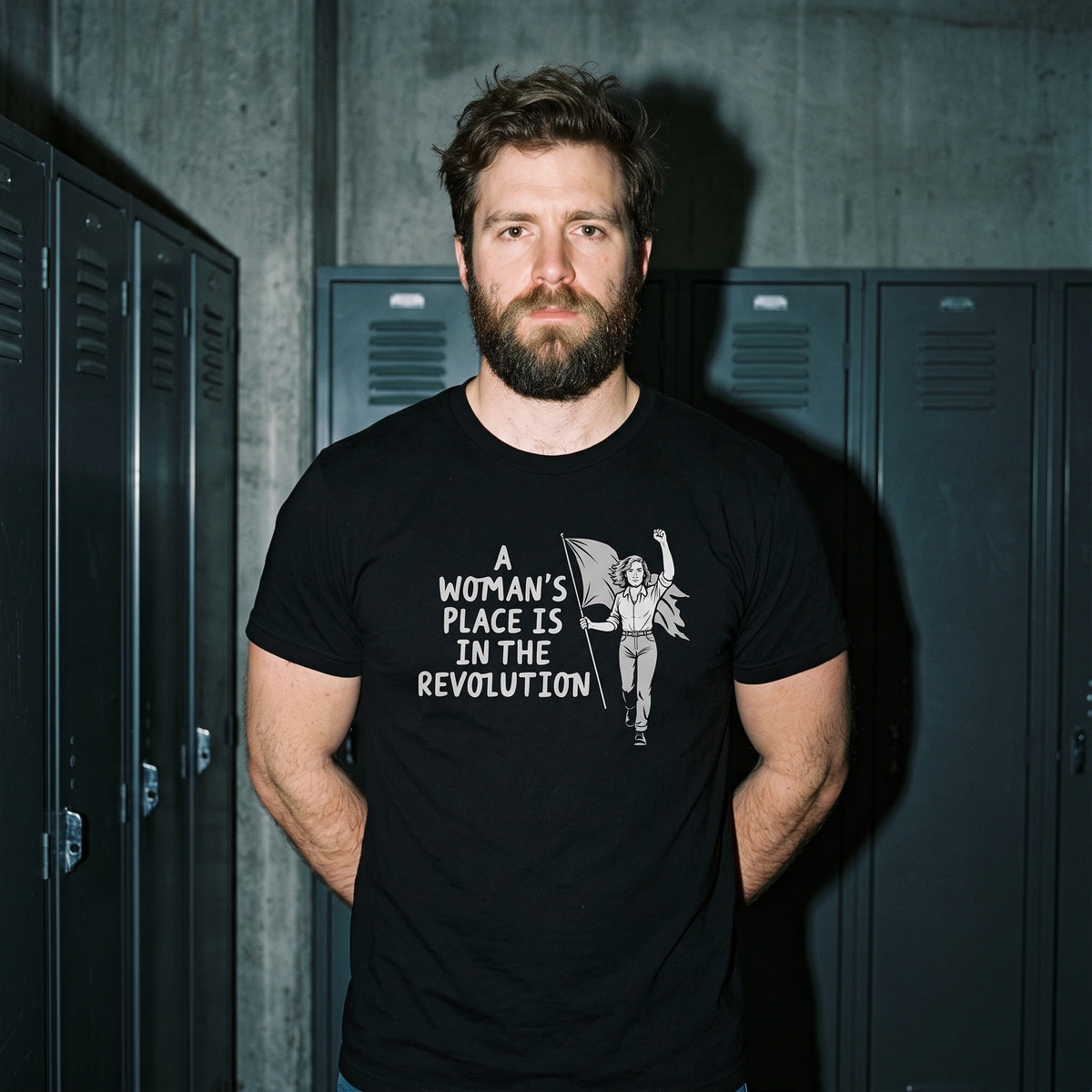 Man wearing the A Woman's Place is in the Revolution black graphic tee