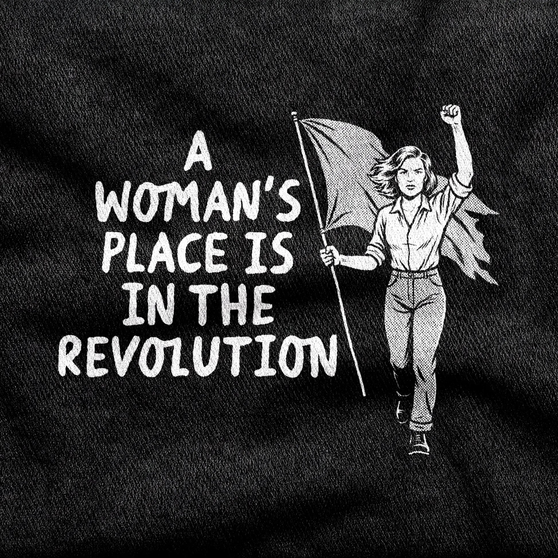 A Woman's Place is in the Revolution design printed on a black cotton tee, close-up