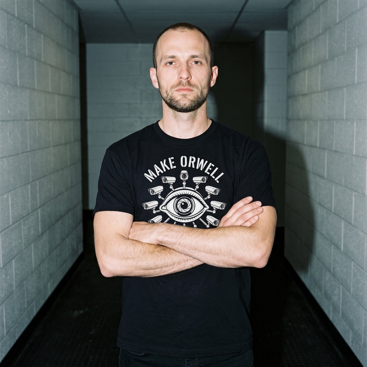 Man wearing the Make Orwell Fiction Again black graphic tee