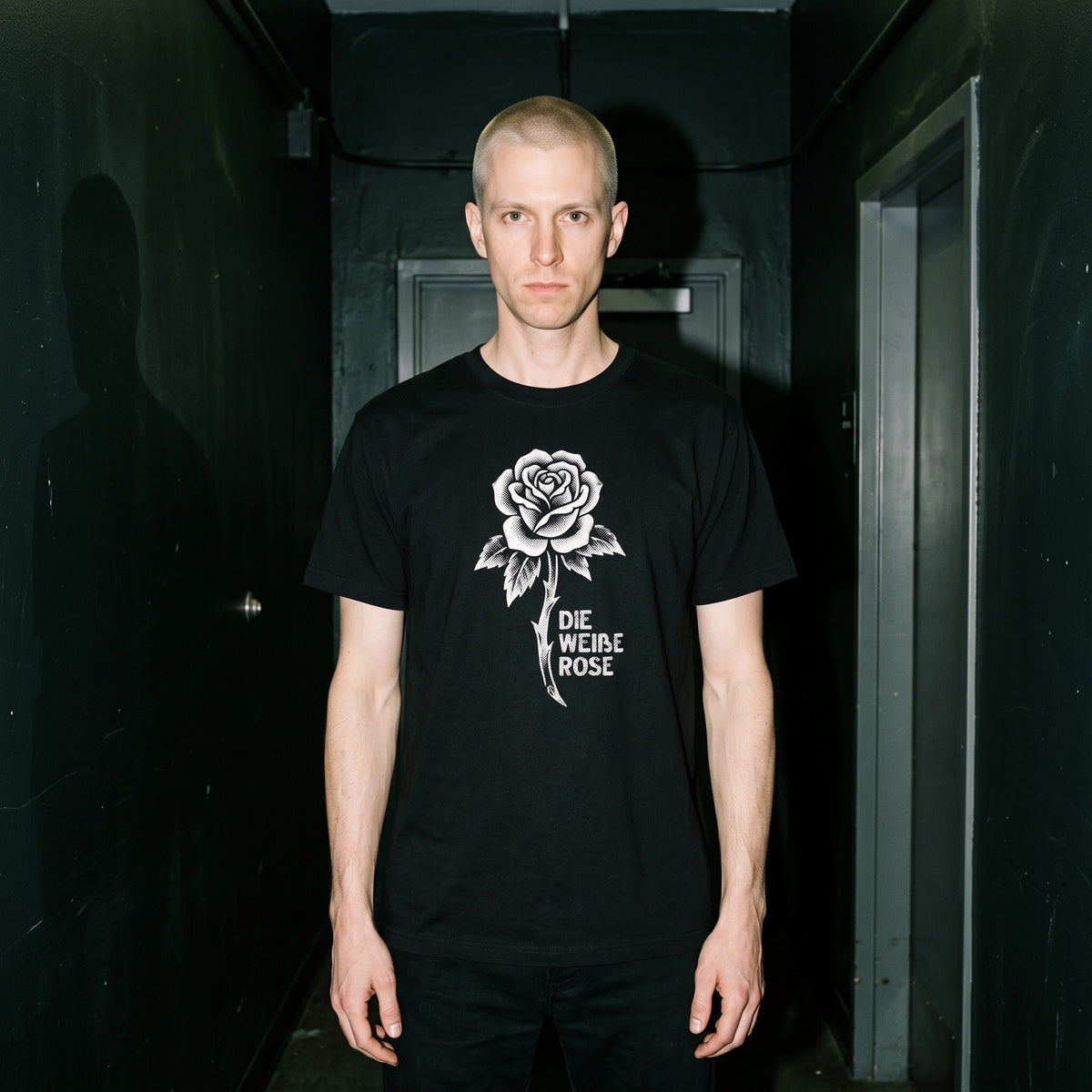 Man wearing the Die Weiße Rose black graphic tee