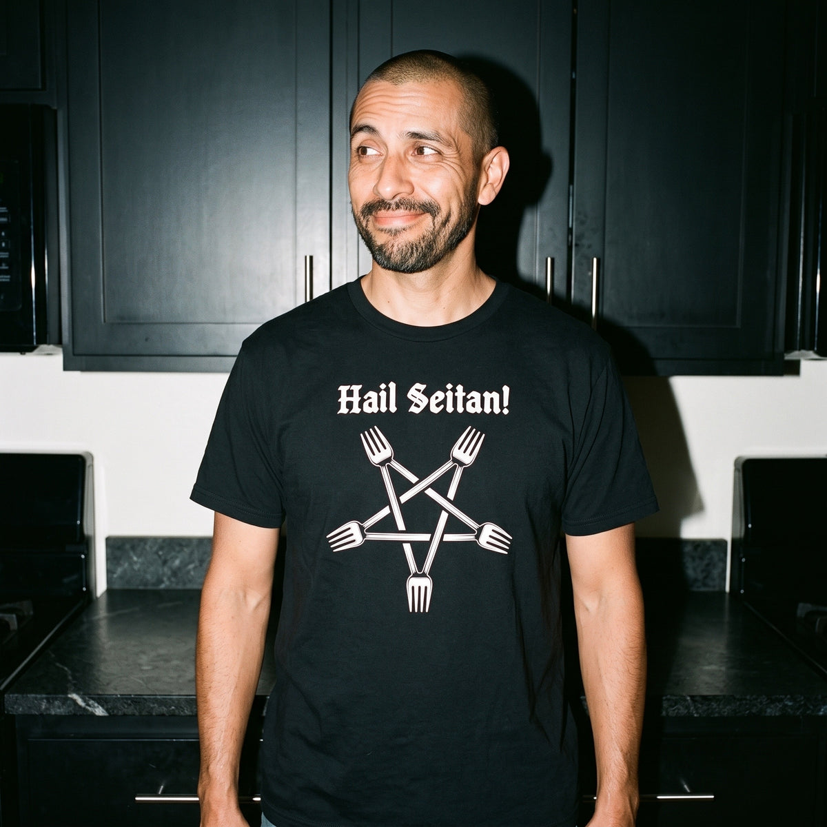Man wearing the Hail Seitan black graphic tee