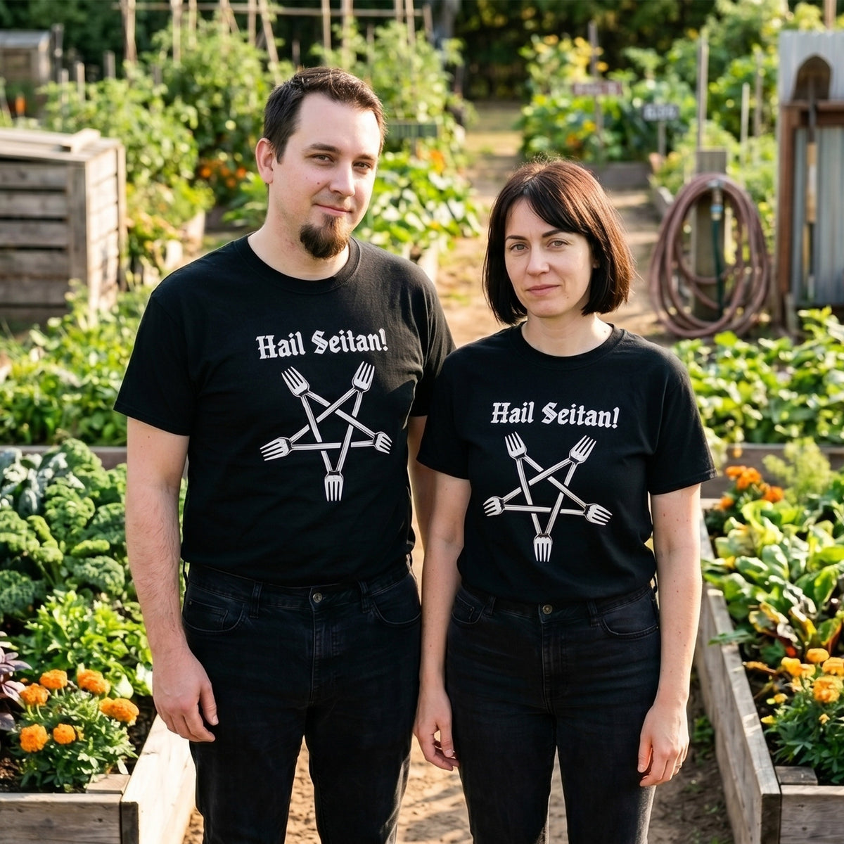 Two models wearing the Hail Seitan black graphic tee