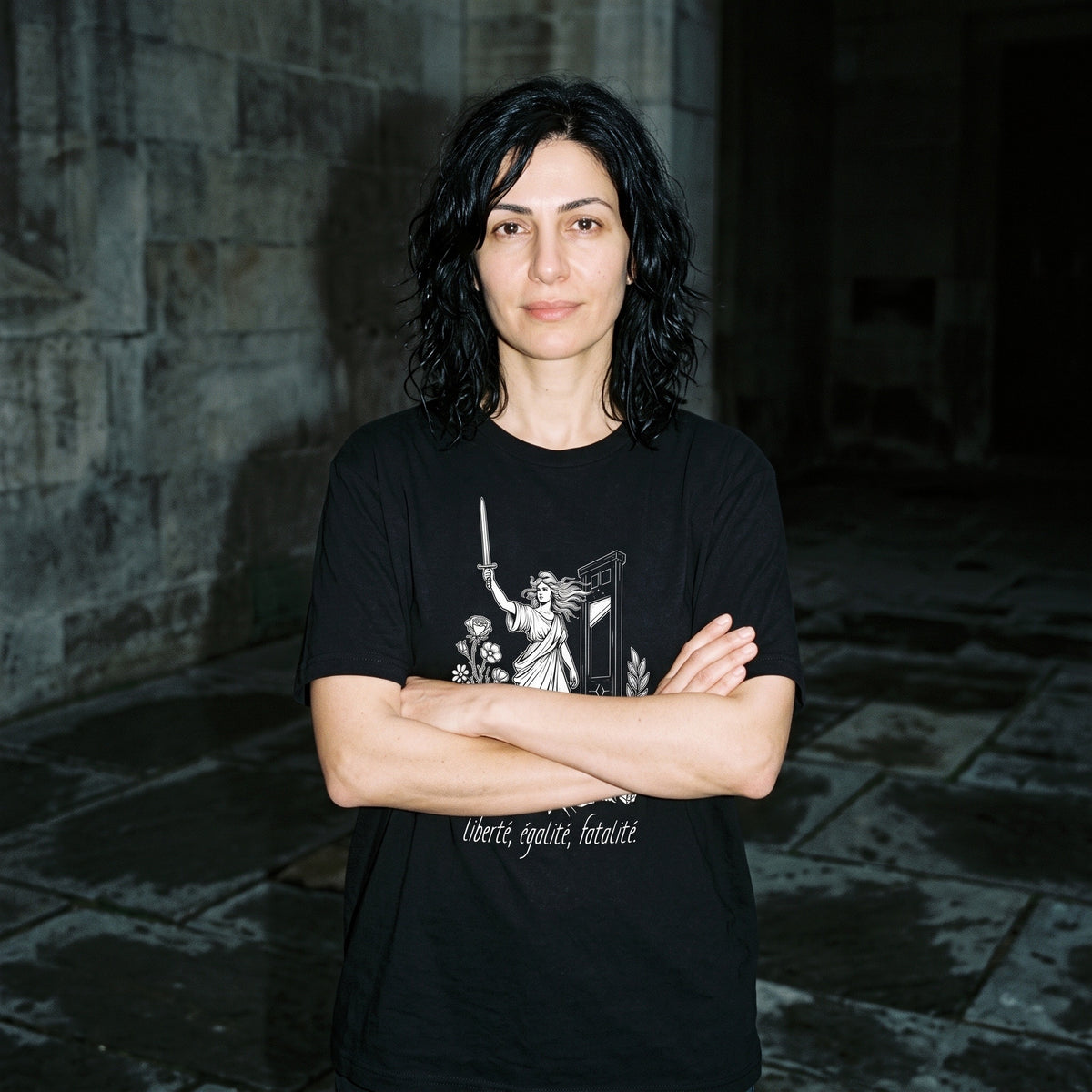 Woman wearing the Liberté Égalité Fatalité black graphic tee
