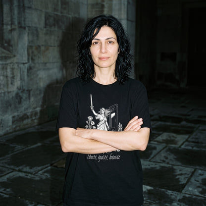 Woman wearing the Liberté Égalité Fatalité black graphic tee
