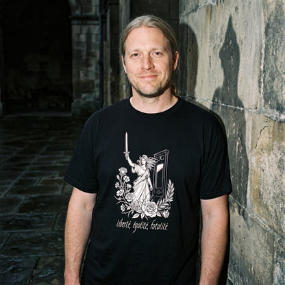 Man wearing the Liberté Égalité Fatalité black graphic tee