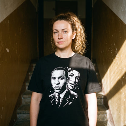 Woman wearing the Frantz Fanon black graphic tee
