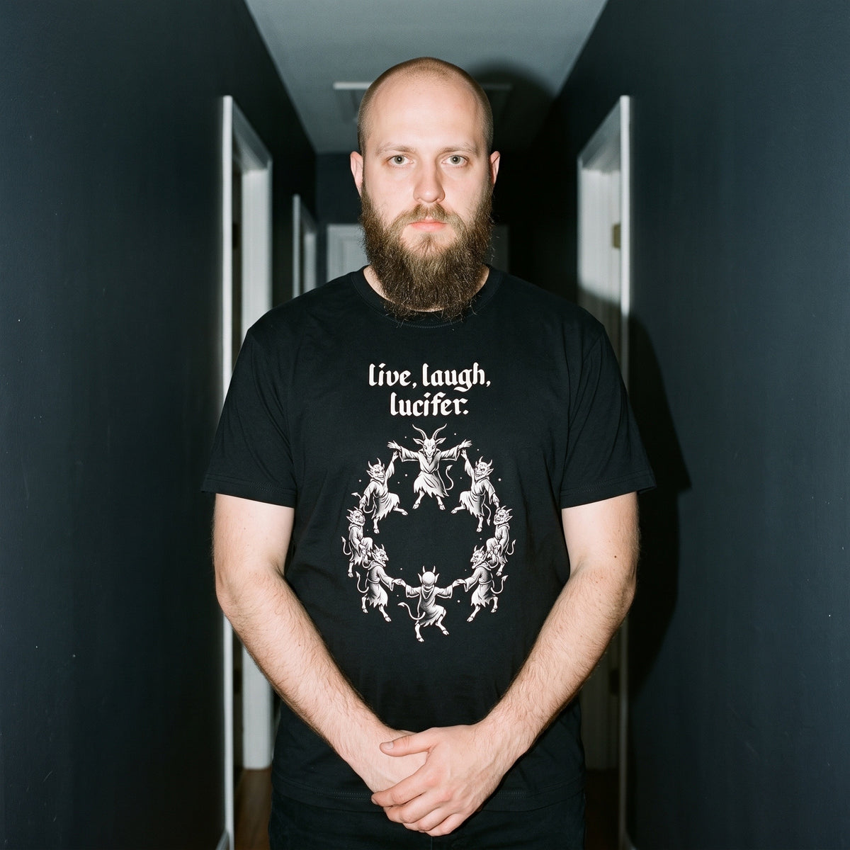 Man wearing the Live Laugh Lucifer black graphic tee