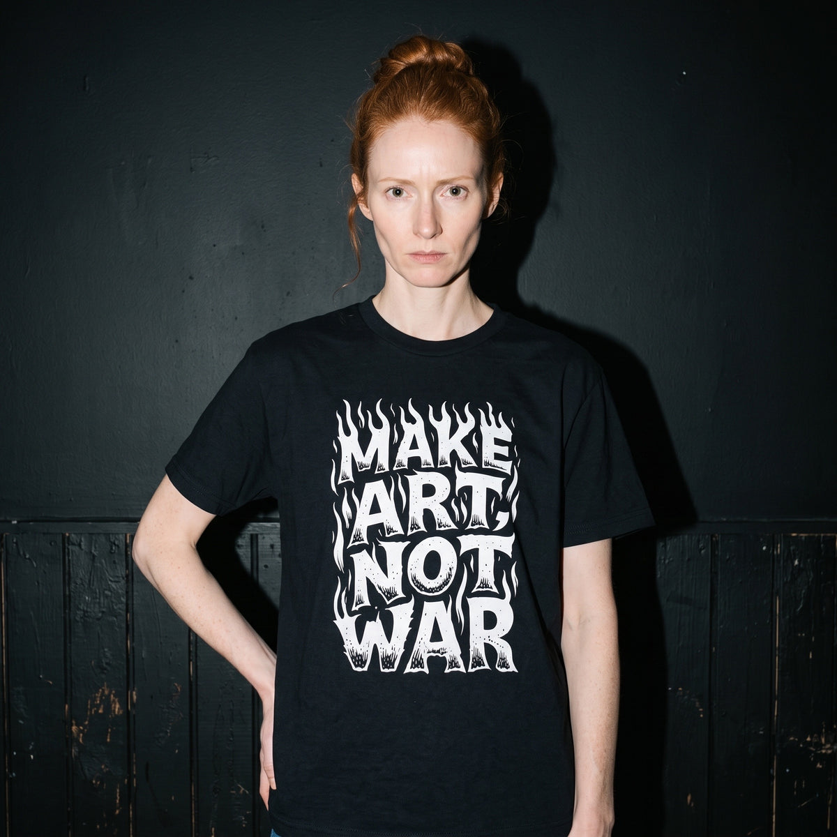 Woman wearing the Make Art Not War black graphic tee