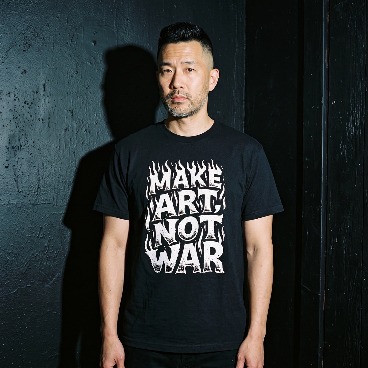 Man wearing the Make Art Not War black graphic tee