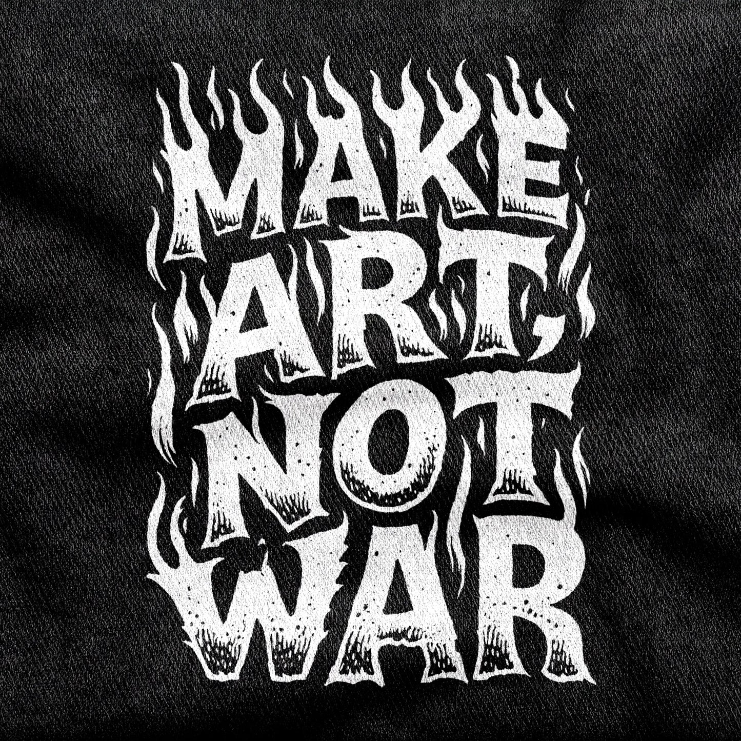 Make Art Not War design printed on a black cotton tee, close-up