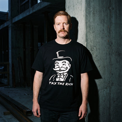 Man wearing the Tax the Rich black graphic tee