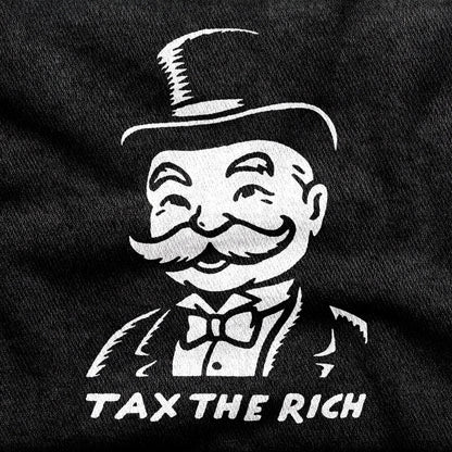 Tax the Rich design printed on a black cotton tee, close-up