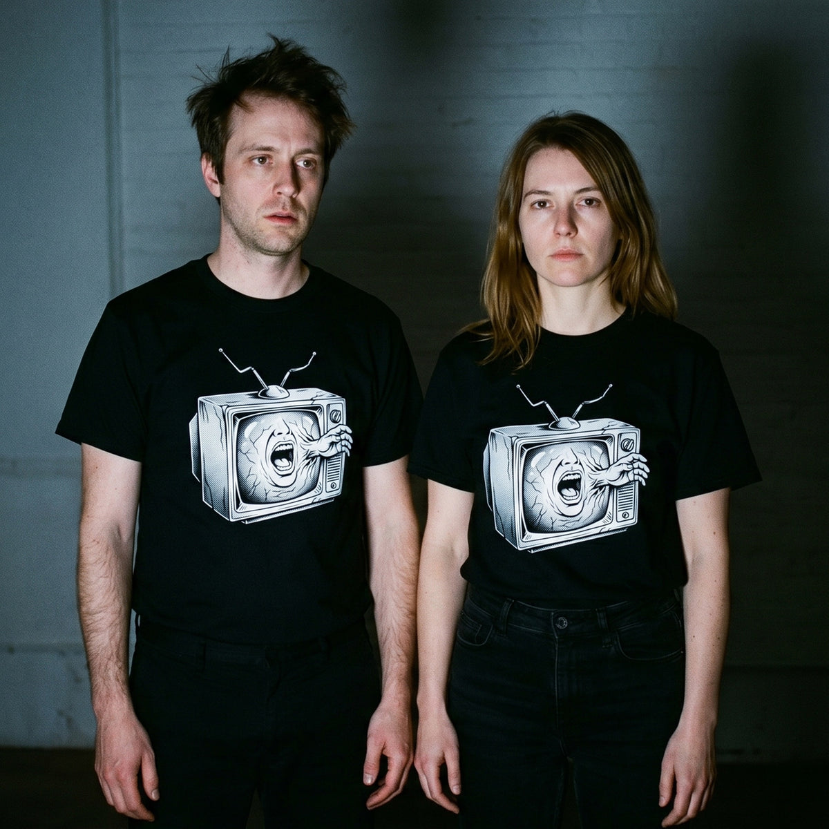 Two models wearing the Videodrome black graphic tee