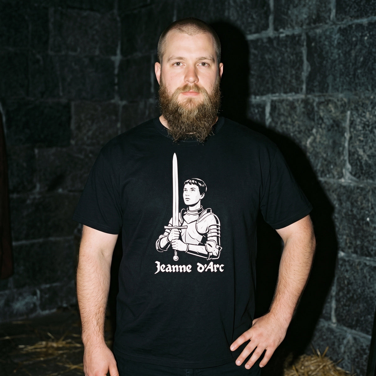Man wearing the Jeanne d'Arc black graphic tee
