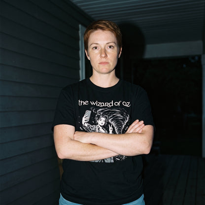 Woman wearing the The Wizard of Oz black graphic tee