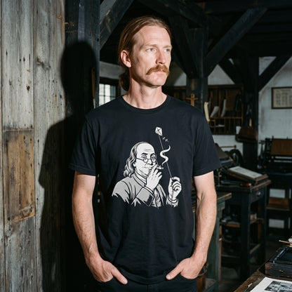 Man wearing the Benjamin Franklin High as a Kite black graphic tee