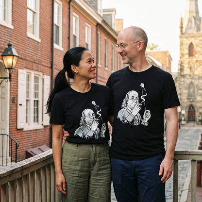 Two models wearing the Benjamin Franklin High as a Kite black graphic tee